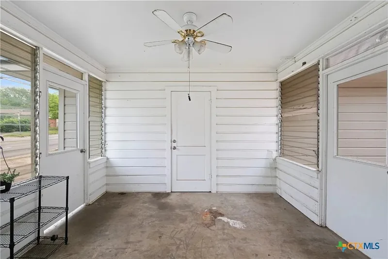 Enclosed breezeway with windows and concrete floor